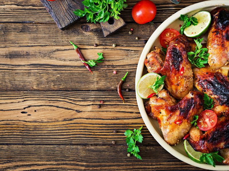 Chicken wings of barbecue in sweetly sour sauce. Picnic. Summer menu. Tasty food. Top view. Flat lay